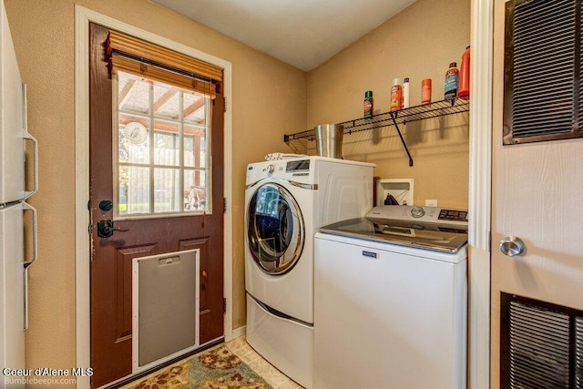 clothes washing area featuring independent washer and dryer and laundry area