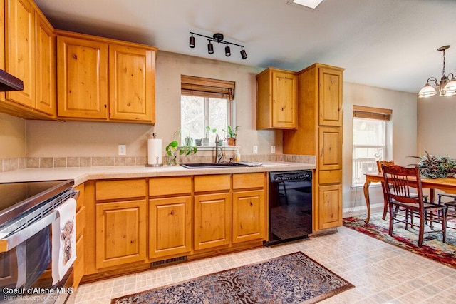 kitchen featuring light countertops, black dishwasher, visible vents, stainless steel electric stove, and a sink