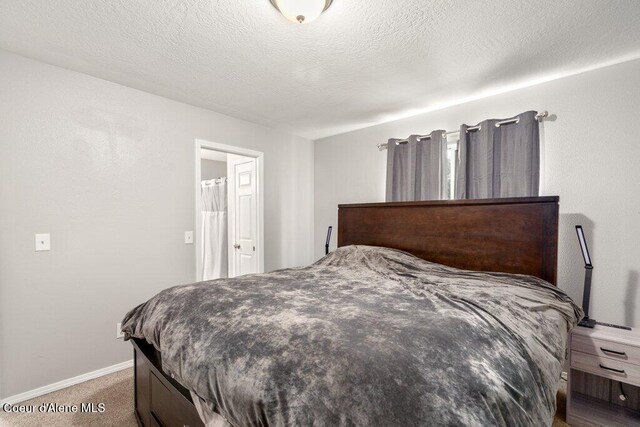 carpeted bedroom with baseboards