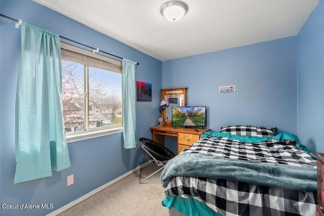 carpeted bedroom with baseboards