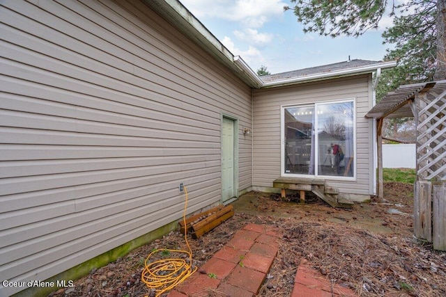 view of side of property featuring fence