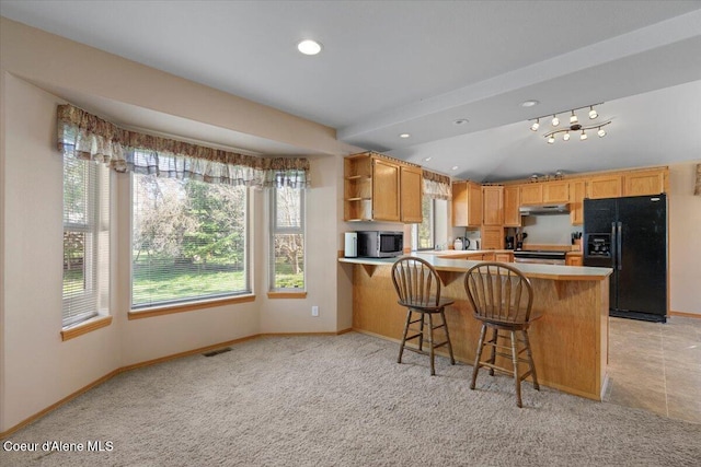 kitchen with stainless steel microwave, baseboards, open shelves, black fridge with ice dispenser, and visible vents