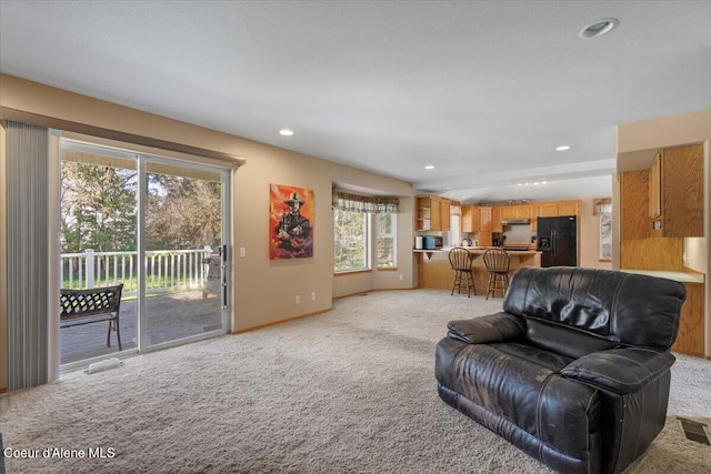 living area featuring visible vents, baseboards, recessed lighting, and light colored carpet