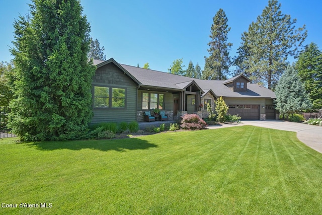 4860 N Cuprum Ct, Coeur Dalene, ID 83815 - view of front of property featuring driveway, a garage, a front yard, stone siding, and covered porch
