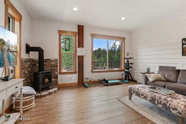137 Bitterroot Pass, Sagle, ID 83860 - living room with a wealth of natural light, a wood stove, baseboards, and wood finished floors