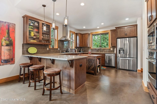 137 Bitterroot Pass, Sagle, ID 83860 - kitchen featuring recessed lighting, a peninsula, backsplash, stainless steel appliances, and finished concrete floors