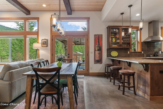 137 Bitterroot Pass, Sagle, ID 83860 - dining area featuring concrete floors, beamed ceiling, a wealth of natural light, and wood ceiling