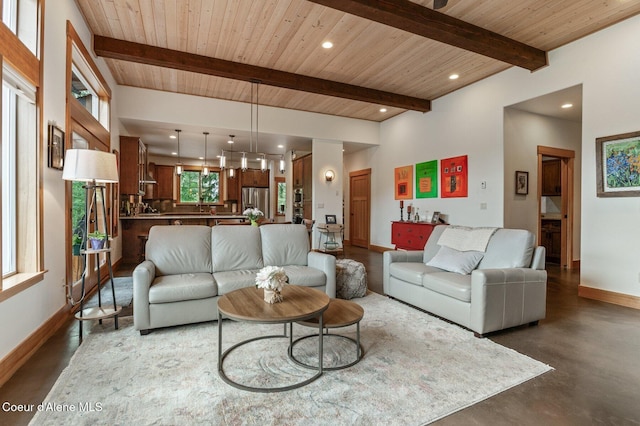 137 Bitterroot Pass, Sagle, ID 83860 - living area with baseboards, wood ceiling, concrete flooring, beam ceiling, and recessed lighting