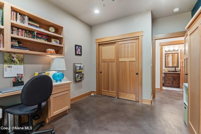 137 Bitterroot Pass, Sagle, ID 83860 - office space featuring concrete floors, built in study area, baseboards, and a sink