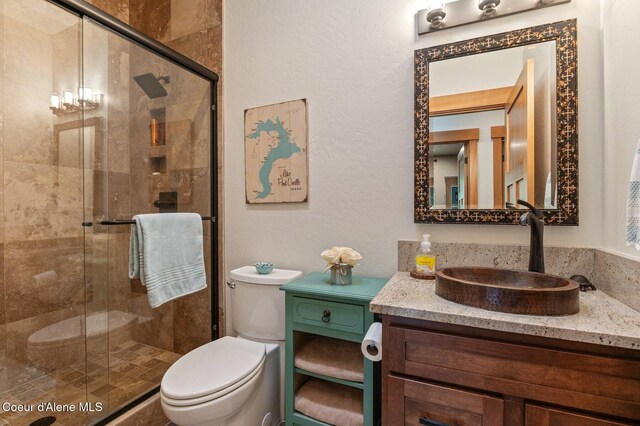 137 Bitterroot Pass, Sagle, ID 83860 - bathroom featuring toilet, a shower stall, and vanity