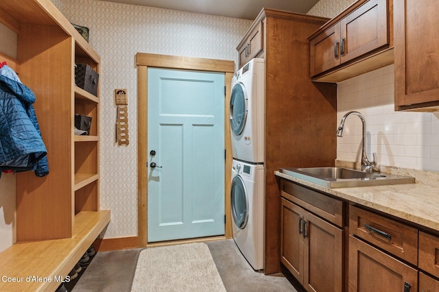 137 Bitterroot Pass, Sagle, ID 83860 - washroom with stacked washing maching and dryer, wallpapered walls, a sink, and cabinet space