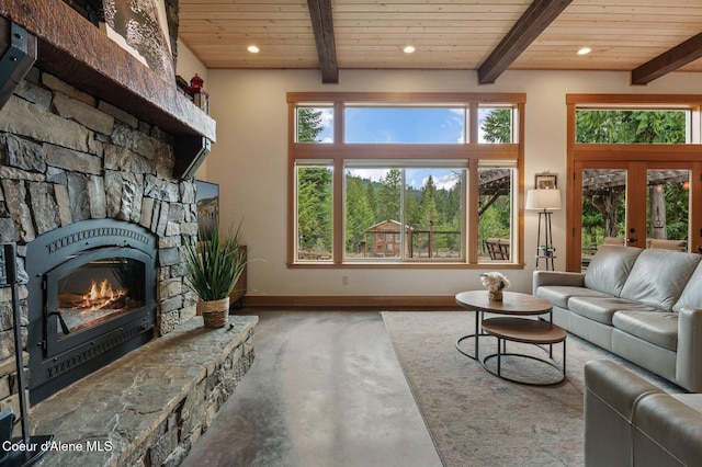 137 Bitterroot Pass, Sagle, ID 83860 - living room featuring beamed ceiling, baseboards, wooden ceiling, and a fireplace