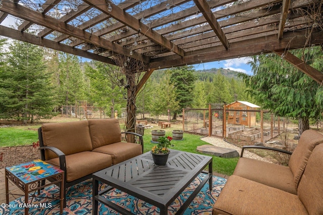 137 Bitterroot Pass, Sagle, ID 83860 - view of patio / terrace with a wooded view, an outdoor hangout area, a pergola, and an outbuilding