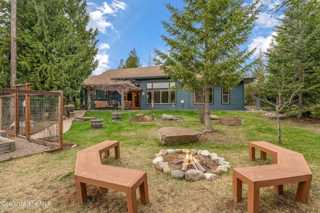 137 Bitterroot Pass, Sagle, ID 83860 - exterior space featuring an outdoor fire pit, a garden, a pergola, and a lawn