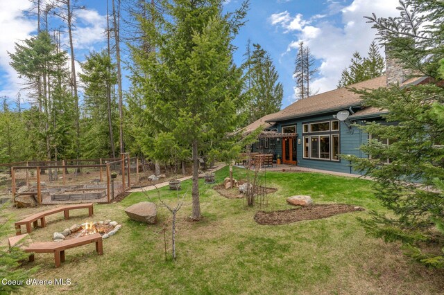 137 Bitterroot Pass, Sagle, ID 83860 - view of yard featuring a patio area, a garden, and a fire pit