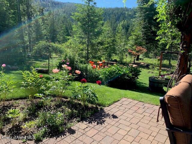 137 Bitterroot Pass, Sagle, ID 83860 - exterior space with a wooded view and a patio