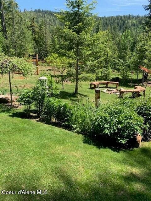 137 Bitterroot Pass, Sagle, ID 83860 - view of home's community featuring a view of trees and a lawn