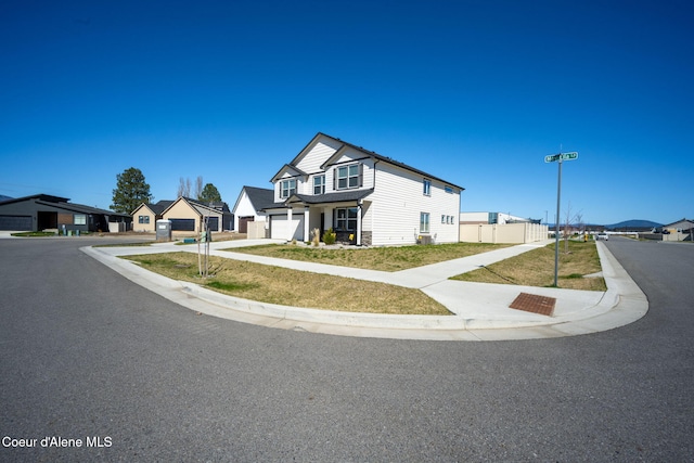 4209 May Ella Lp, Post Falls, ID 83854 - modern farmhouse style home with concrete driveway, a front lawn, a residential view, and a garage