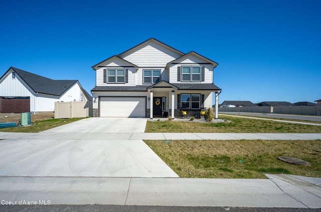 4209 May Ella Lp, Post Falls, ID 83854 - craftsman inspired home with stone siding, an attached garage, driveway, and fence