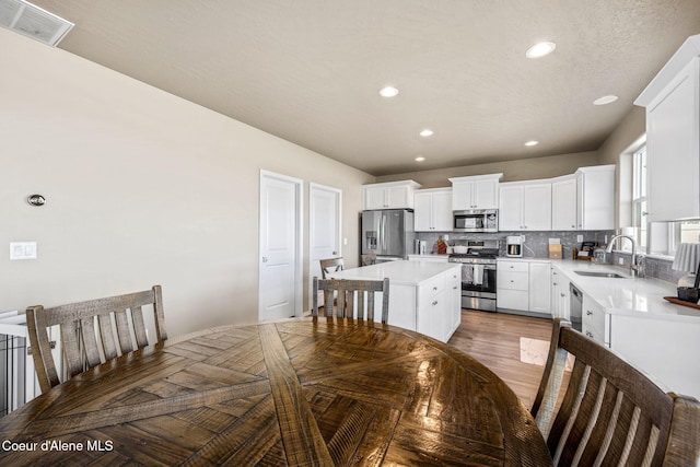 4209 May Ella Lp, Post Falls, ID 83854 - kitchen featuring a center island, tasteful backsplash, a sink, stainless steel appliances, and visible vents