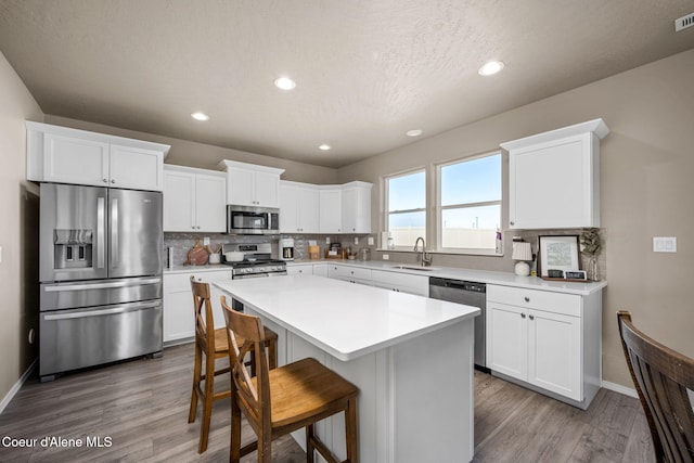 4209 May Ella Lp, Post Falls, ID 83854 - kitchen with stainless steel appliances, wood finished floors, a sink, and backsplash