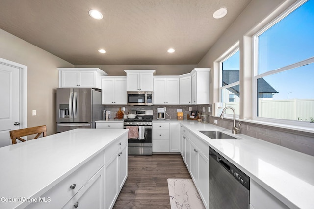 4209 May Ella Lp, Post Falls, ID 83854 - kitchen with stainless steel appliances, backsplash, light countertops, a sink, and white cabinetry
