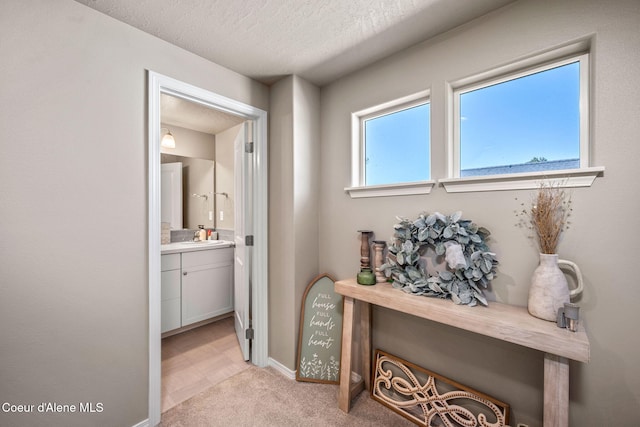 4209 May Ella Lp, Post Falls, ID 83854 - hallway with a textured ceiling, baseboards, and light carpet