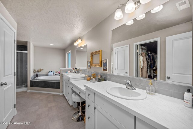 4209 May Ella Lp, Post Falls, ID 83854 - bathroom featuring a bath, a sink, a shower stall, and double vanity
