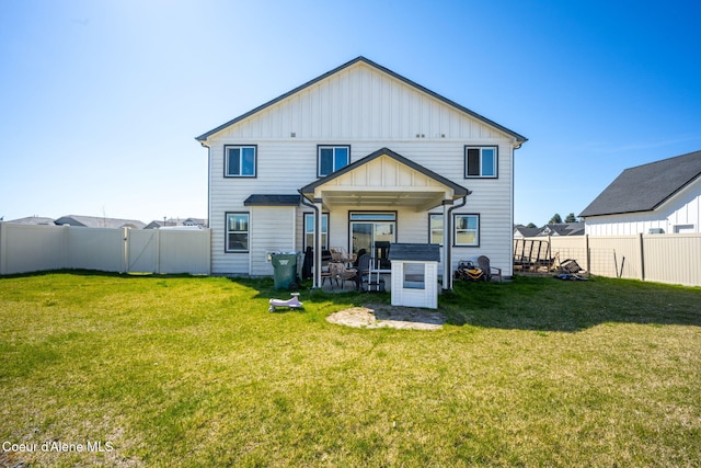 4209 May Ella Lp, Post Falls, ID 83854 - back of house featuring board and batten siding, a patio area, a fenced backyard, and a yard