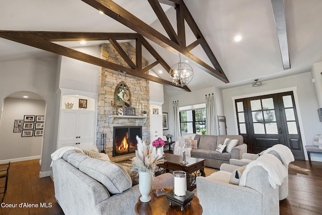 living room with beam ceiling, baseboards, high vaulted ceiling, and arched walkways