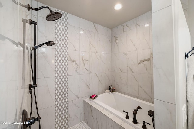 bathroom with a tile shower and tiled bath