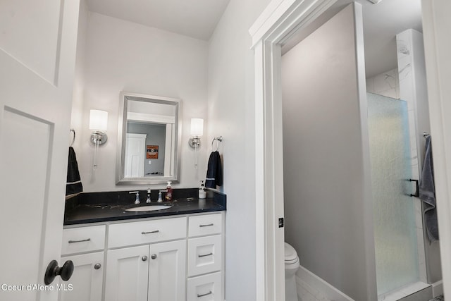 bathroom featuring a shower stall, vanity, and toilet