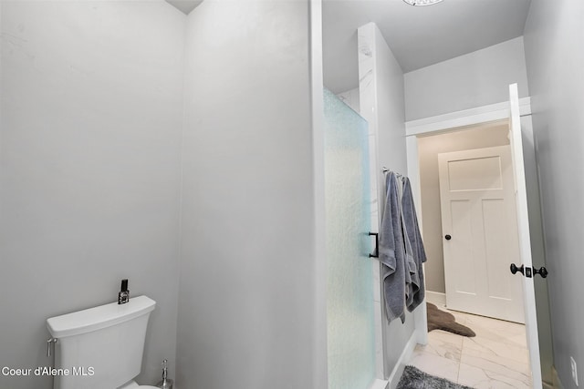 full bathroom with toilet, marble finish floor, and walk in shower