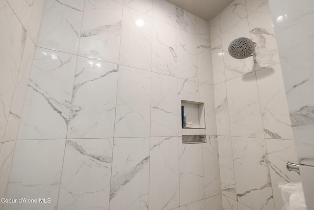 full bath with tiled shower