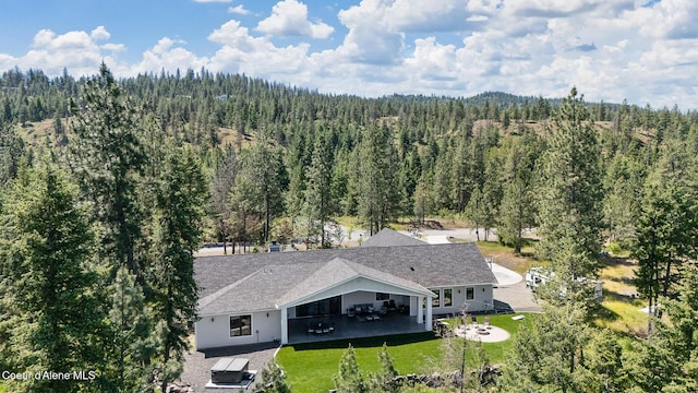 birds eye view of property with a view of trees