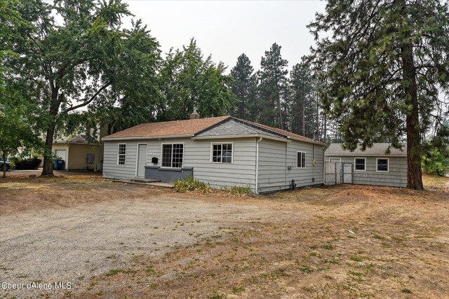 1813 N Spokane St, Post Falls, ID 83854 - rear view of house with a chimney