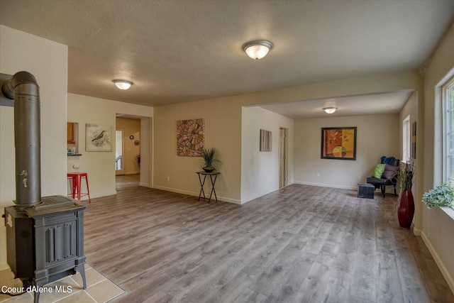 1813 N Spokane St, Post Falls, ID 83854 - living area featuring wood finished floors, a wood stove, and baseboards
