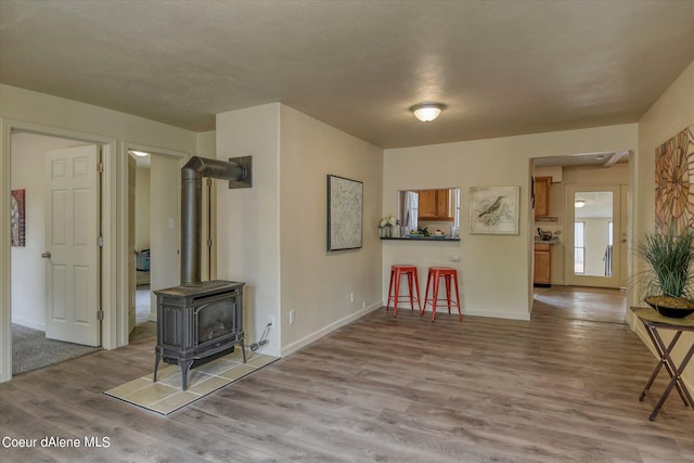 1813 N Spokane St, Post Falls, ID 83854 - interior space with a wood stove, baseboards, and wood finished floors