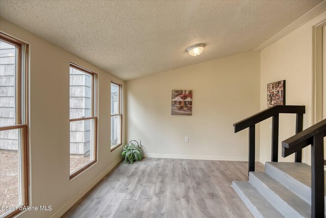 1813 N Spokane St, Post Falls, ID 83854 - interior space with plenty of natural light, a textured ceiling, and wood finished floors