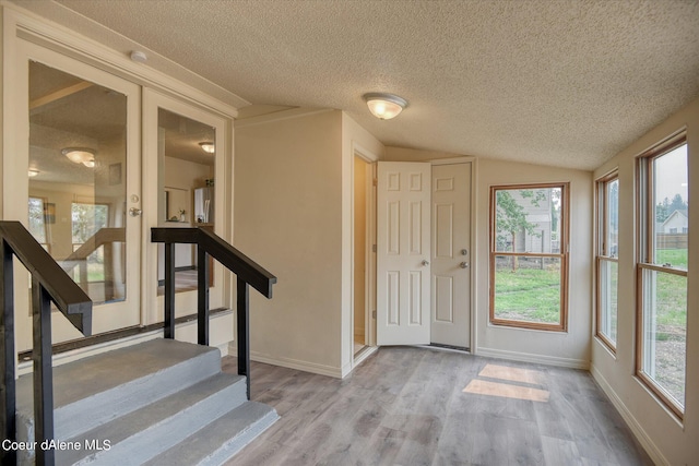 1813 N Spokane St, Post Falls, ID 83854 - entrance foyer with vaulted ceiling, stairs, wood finished floors, and a textured ceiling