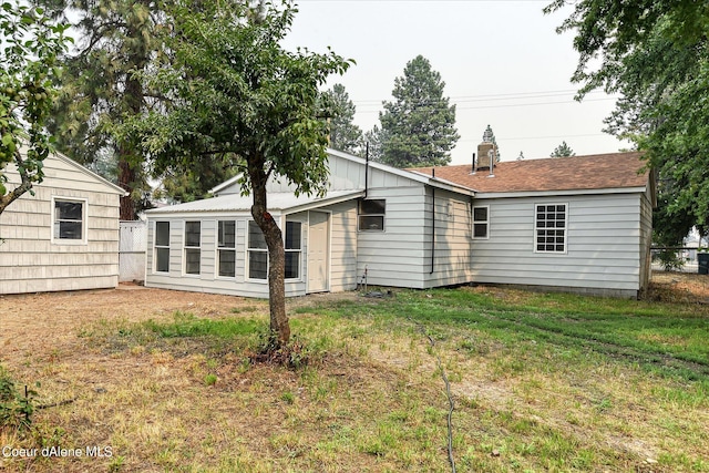 1813 N Spokane St, Post Falls, ID 83854 - rear view of house with a yard