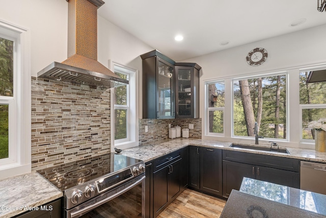 26 Hanaford Rd, Blanchard, ID 83804 - kitchen featuring wall chimney range hood, appliances with stainless steel finishes, decorative backsplash, a sink, and recessed lighting