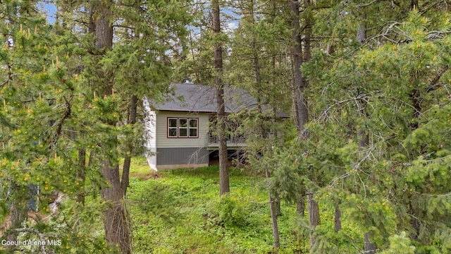 26 Hanaford Rd, Blanchard, ID 83804 - back of house featuring roof with shingles and a forest view