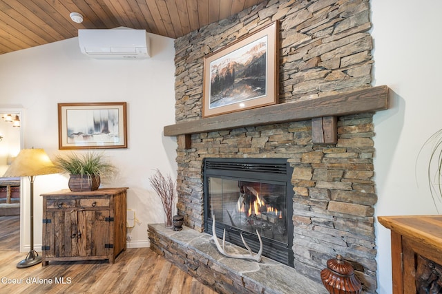 26 Hanaford Rd, Blanchard, ID 83804 - detailed view of a wall mounted AC, wooden ceiling, a stone fireplace, wood finished floors, and a smoke detector