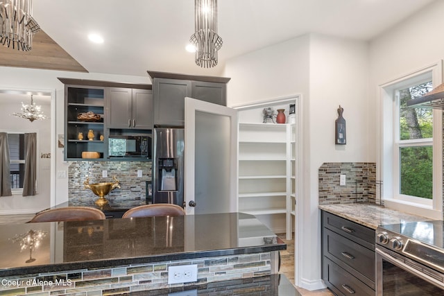 26 Hanaford Rd, Blanchard, ID 83804 - kitchen with stainless steel appliances, tasteful backsplash, stone counters, a chandelier, and open shelves