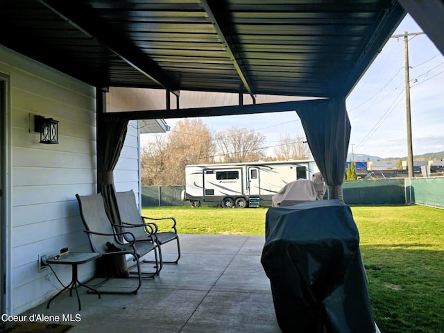view of patio / terrace with fence and a grill