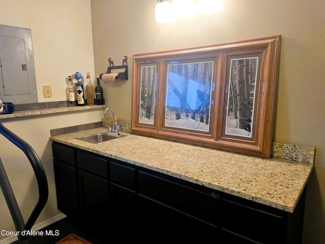 bar with wet bar, a sink, and electric panel