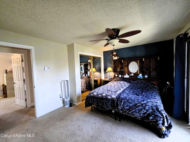 carpeted bedroom featuring a ceiling fan, a textured ceiling, and a closet