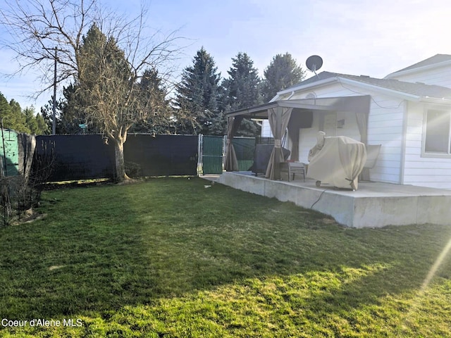 view of yard featuring a patio and fence
