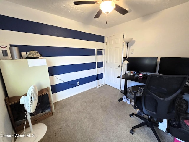 carpeted office with a ceiling fan